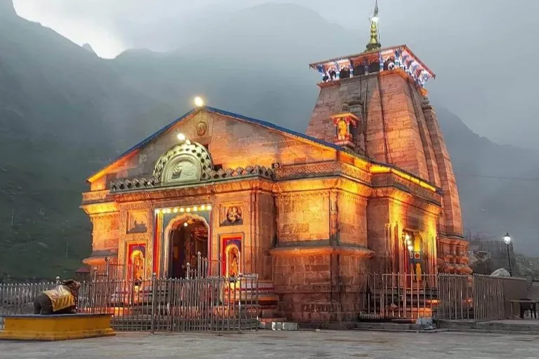 The illuminated Kedarnath temple against the Garhwal Himalaya at dusk