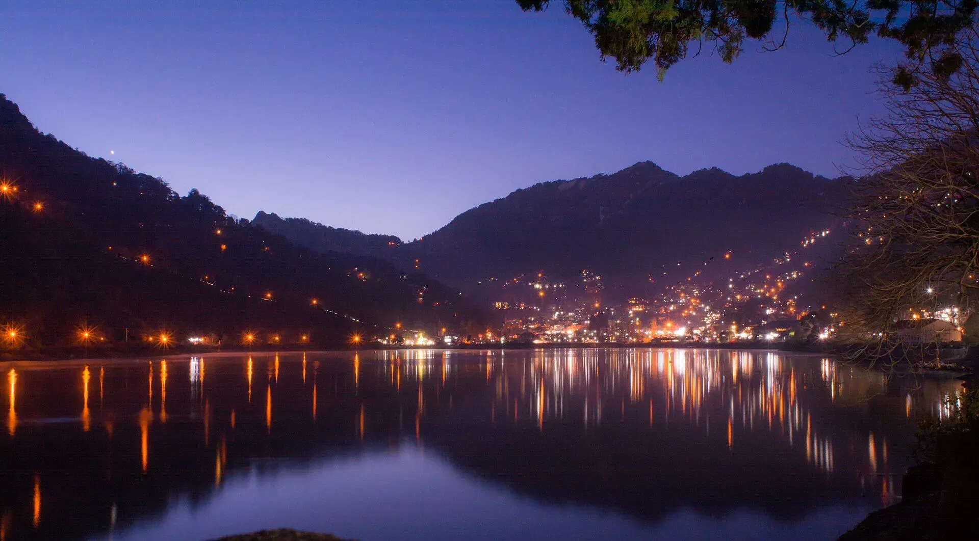Nainital lake at night with the hillside town lights reflected in the water